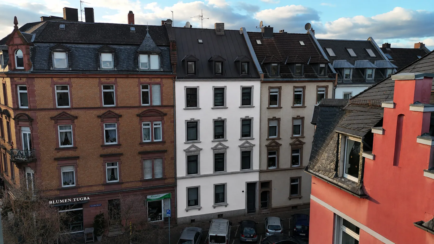 Der Altbau N°36 in Schwarzweiß aus der Luft, eingebunden in die geschlossene Häuserzeile der Straße.